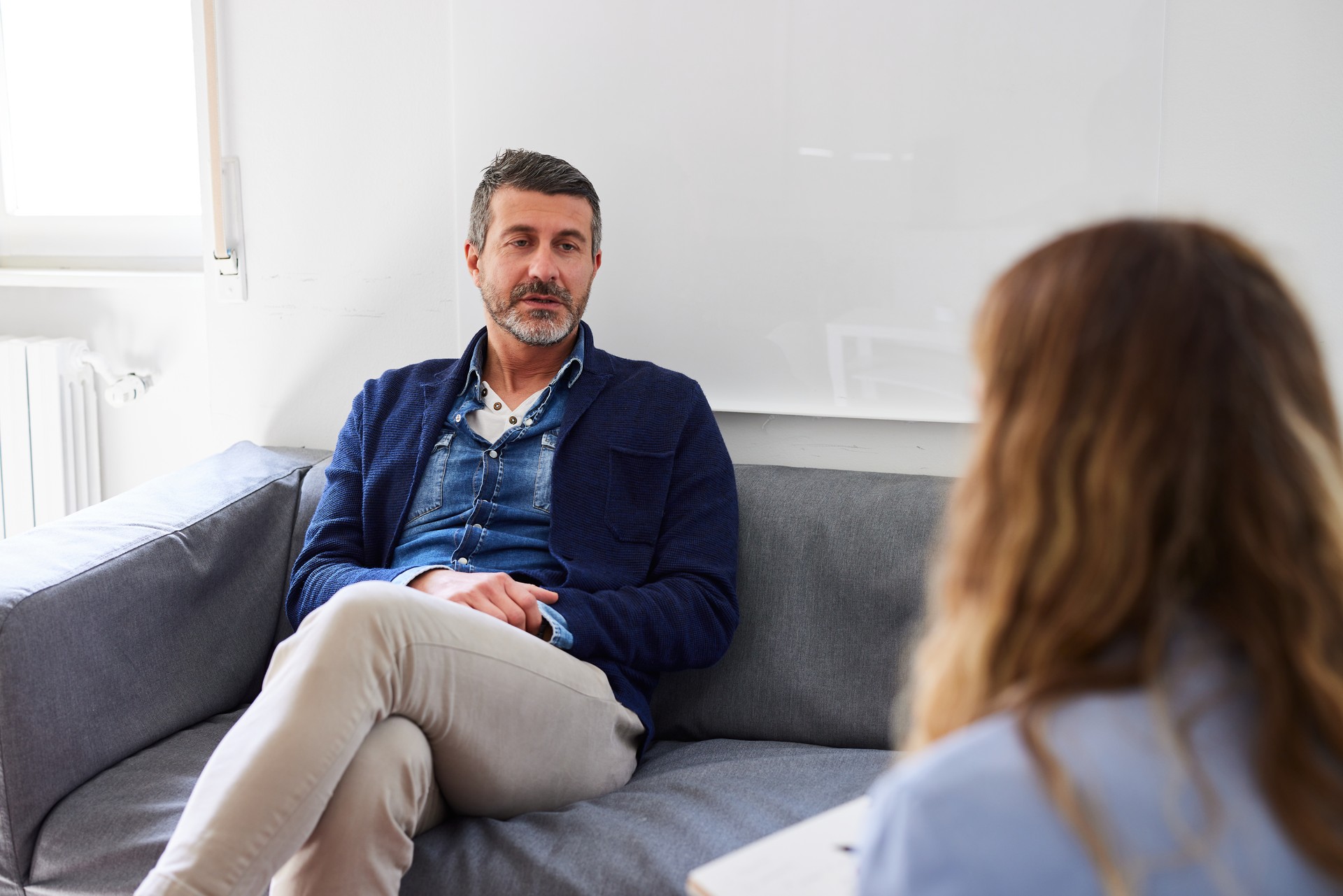 Man sharing his problems with psychologist during therapy session